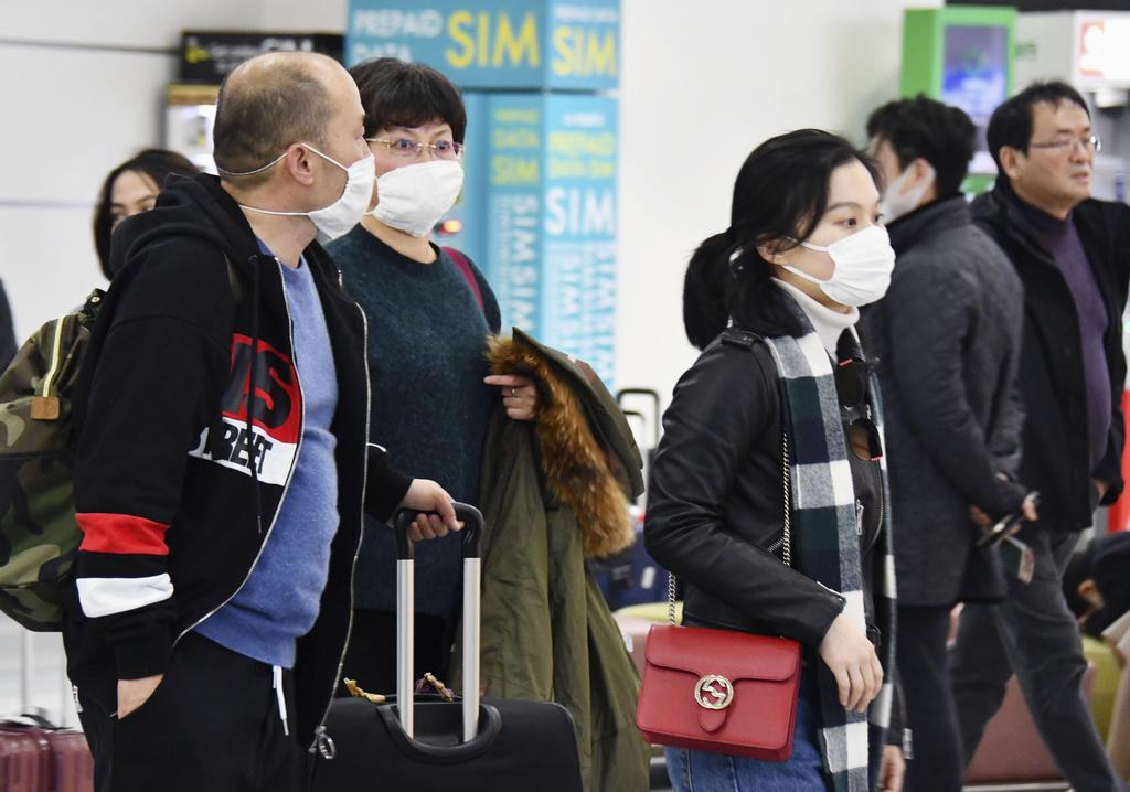 マスクをして福岡空港に到着した中国人旅行者ら=1月25日