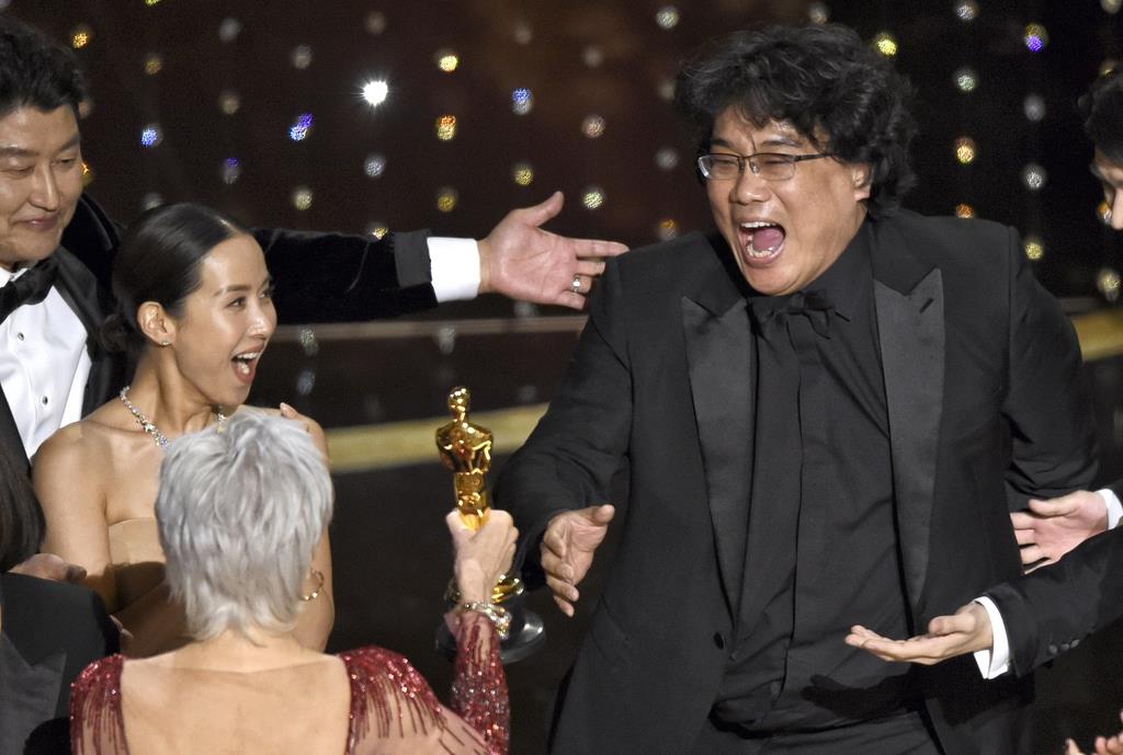第92回アカデミー賞で、作品賞を受賞し喜びを爆発させる「パラサイト 半地下の家族」のポン・ジュノ監督(右)ら=2020年2月9日、米ハリウッド(AP)