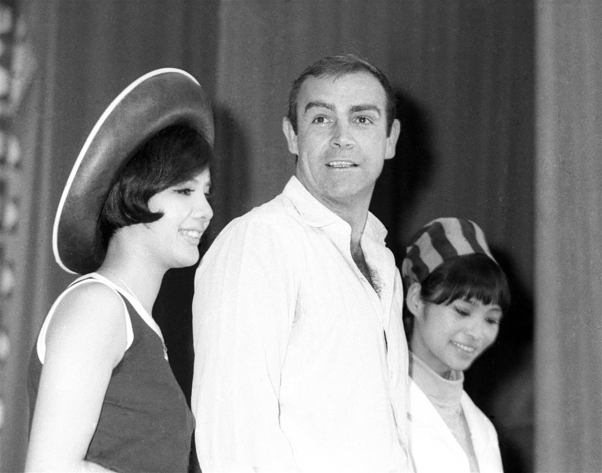 1966年7月、スパイ映画「007は二度死ぬ」のロケで来日、記者会見でボンドガールの浜美枝さん(左)、若林映子さん(右)と写真に納まるショーン・コネリーさん=東京都内のホテル