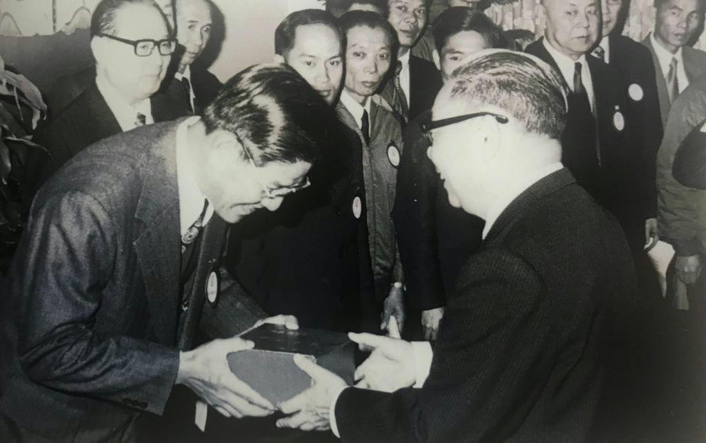台湾・行政院長の蒋経国(手前右)から記念品を受け取る政務委員の李登輝=1970年代(李登輝基金会提供)