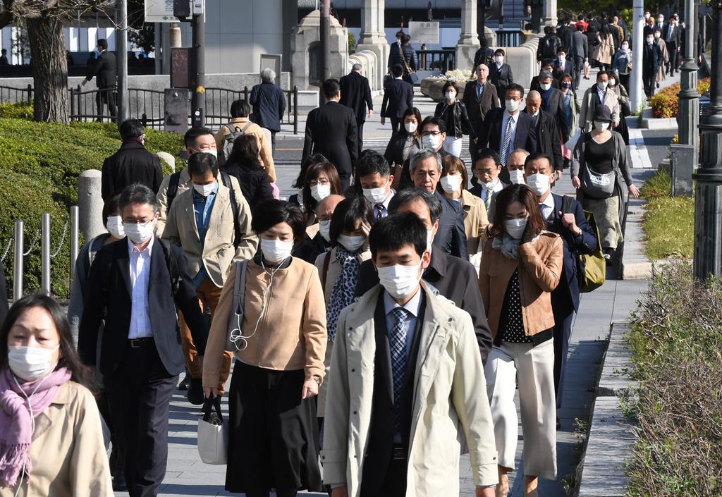 新型コロナウイルスの感染防止のためマスク着用で通勤する人たち=7日午前8時21分、大阪市北区 (安元雄太撮影)