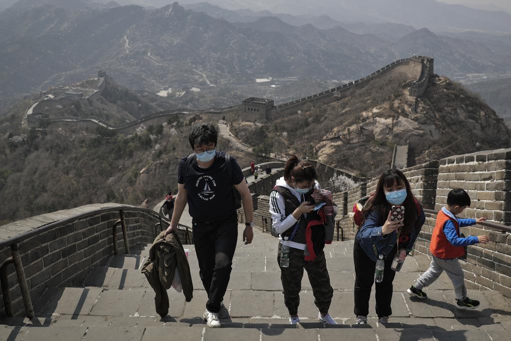 １４日、マスク姿で北京の万里の長城を訪れる観光客(ＡＰ)